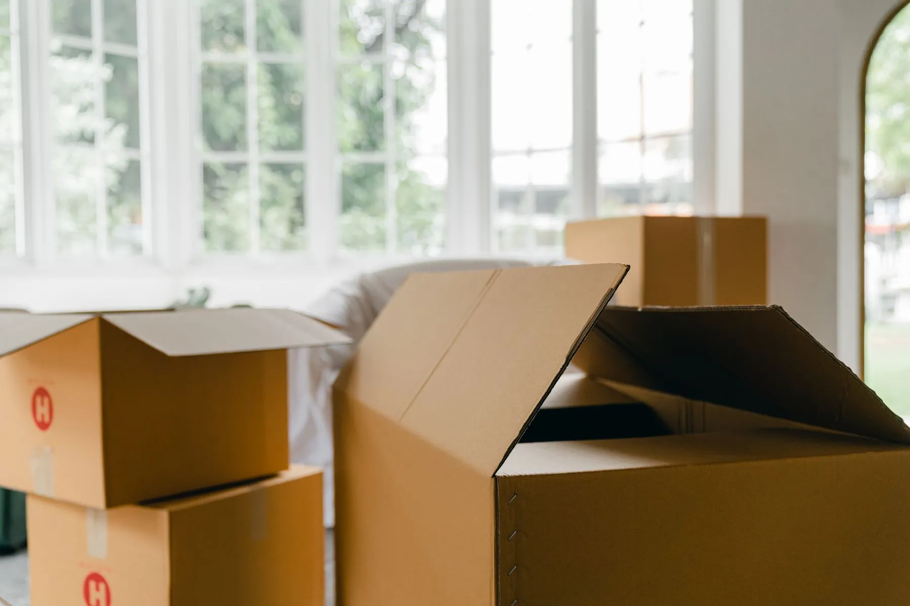 Moving boxes arranged in a bright residential room